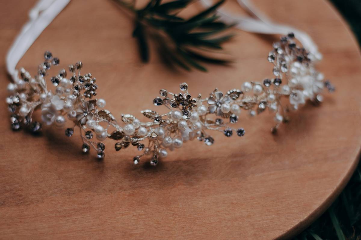 Close-up of delicate crystal wedding crowns on velvet display