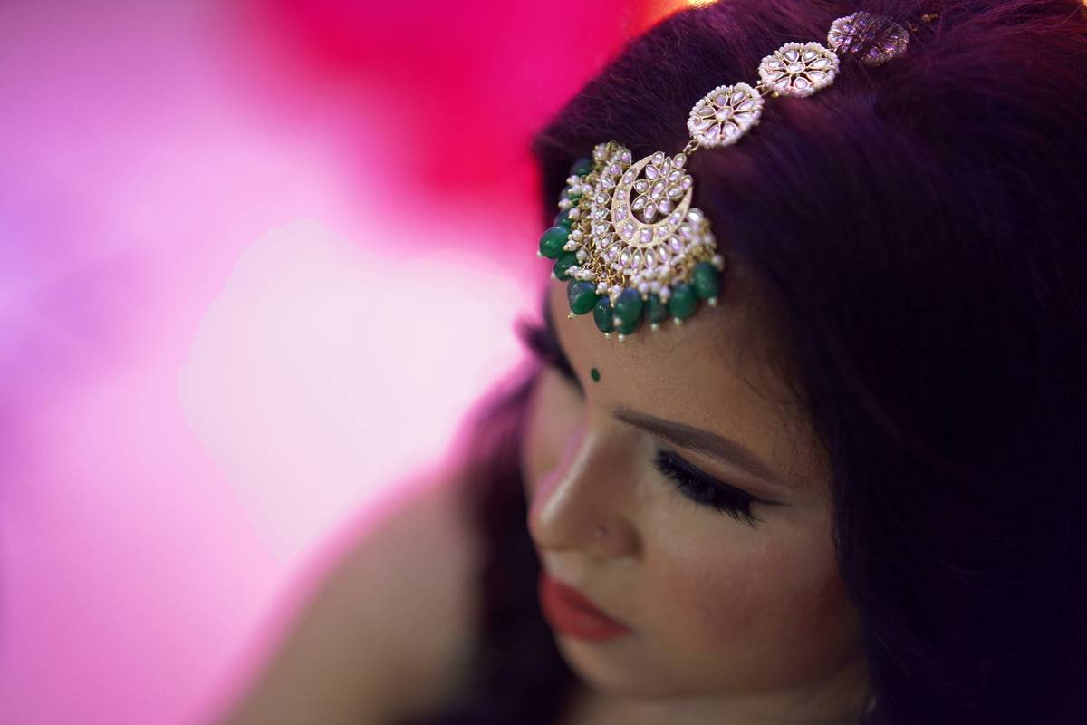 Bride wearing elegant crystal wedding crowns with soft updo hairstyle