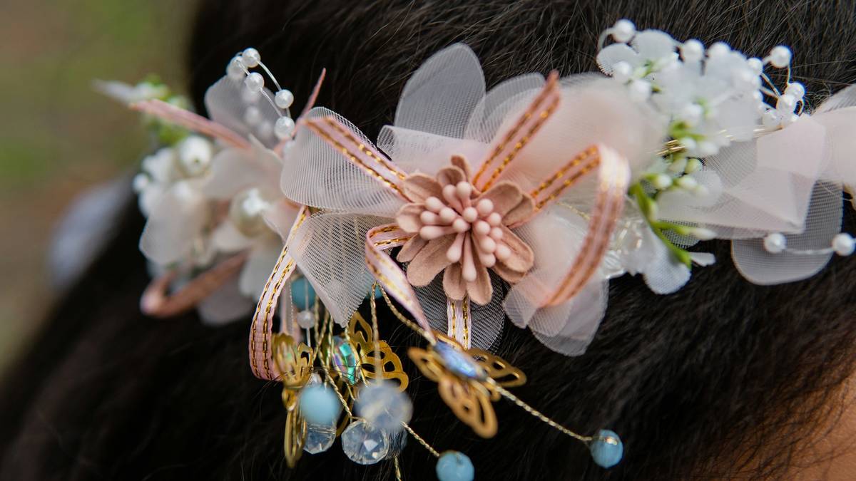 Close-up of silver wedding headbands on mannequin showing secure fit and light reflection