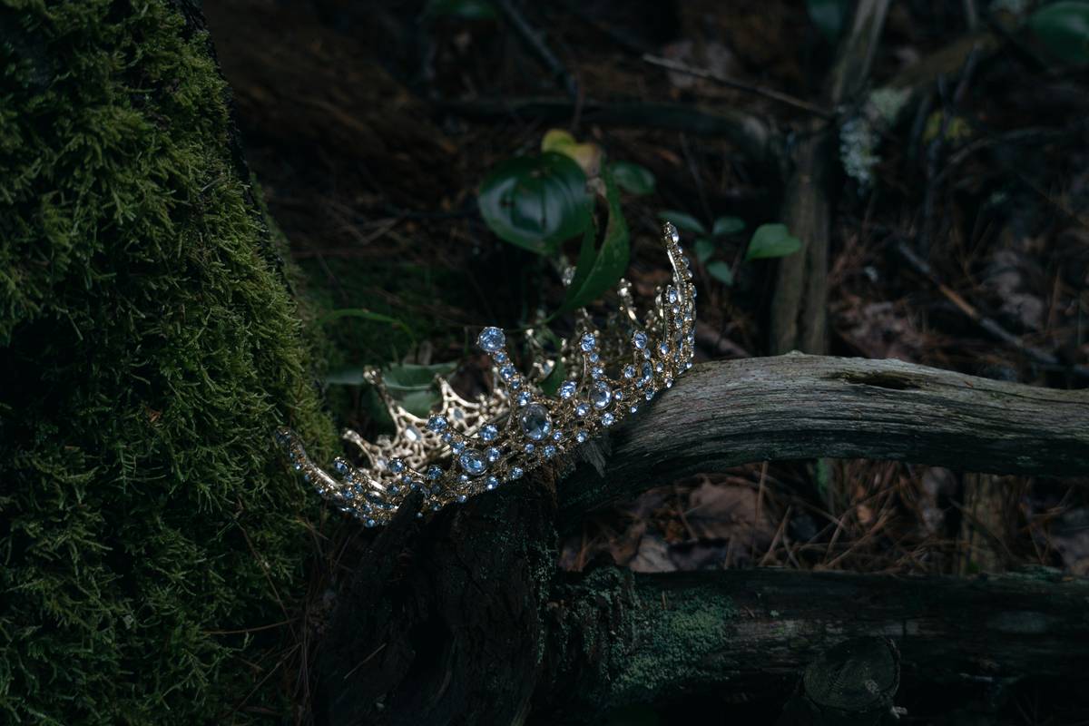 pageant headpiece styles featuring a crystal-encrusted hair crown on a mannequin with voluminous curls