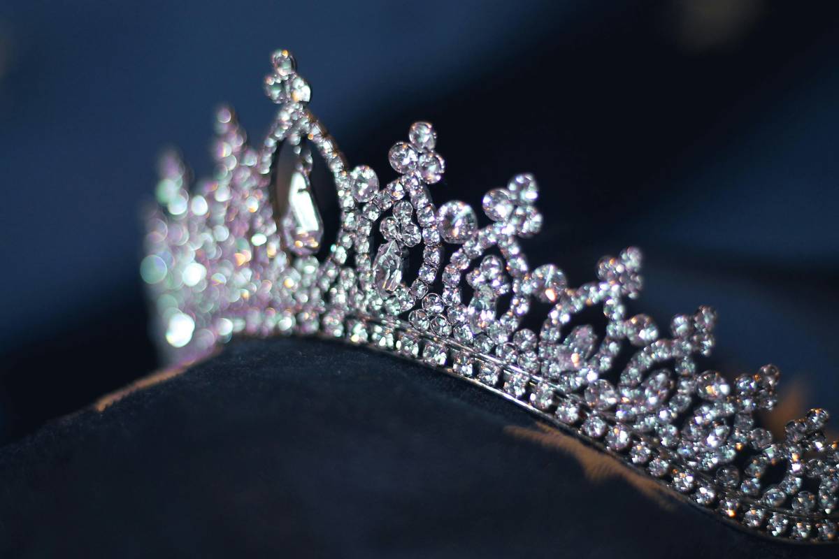 Modern bridal tiaras on a velvet display stand with soft lighting highlighting minimalist gold and silver designs